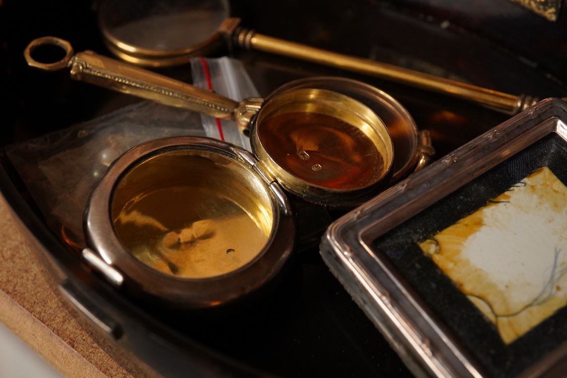An Edwardian tortoiseshell jewellery box, a pair of gilt metal lorgnettes, a pair of half hoop gold earrings and pearl earrings, three jars etc